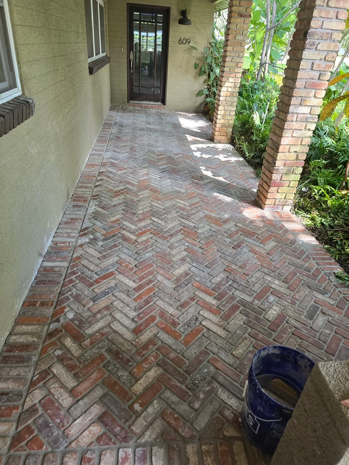 Brick paver walkway running alongside a home