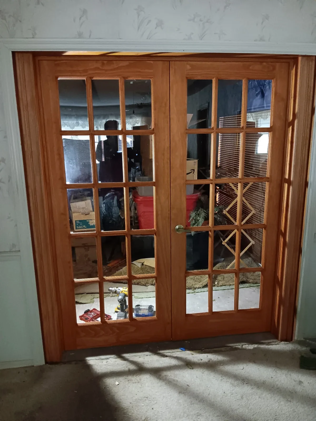 Wood-framed glass French doors between two interior rooms