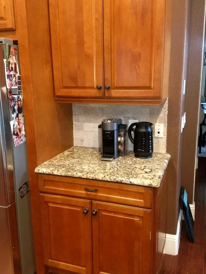 Oak-tone kitchen cabinet doors above a light countertop